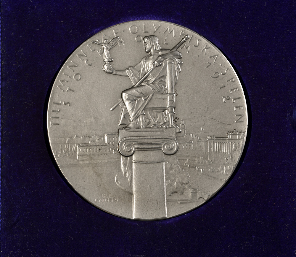 Team silver rowing medal from the 1912 Stockholm Olympic Games; presented to Tom Gillespie and gifted to College by his family.