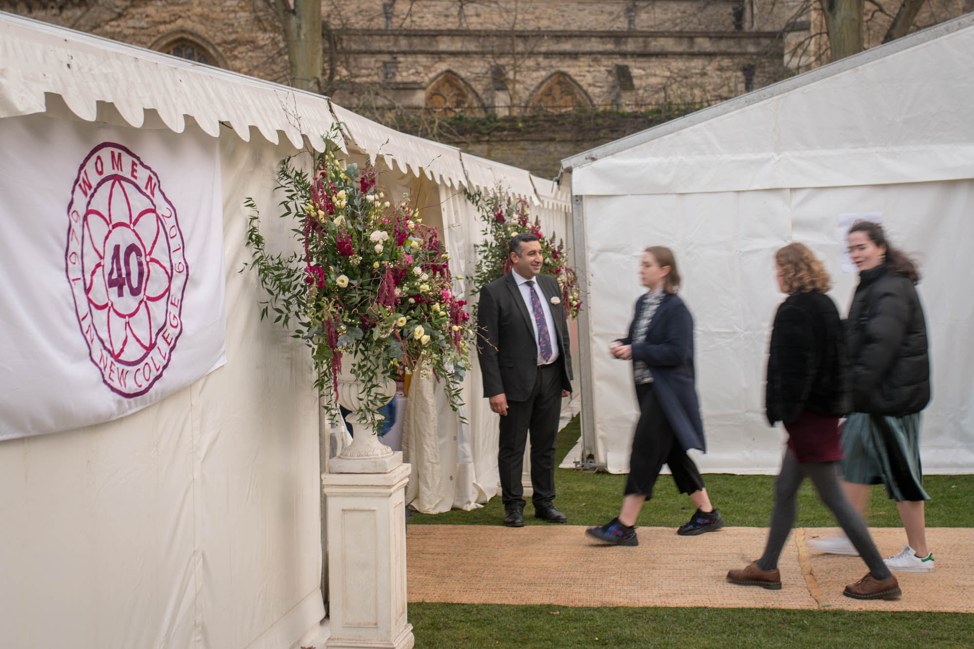 Attendees enter the marquee in the Gardens