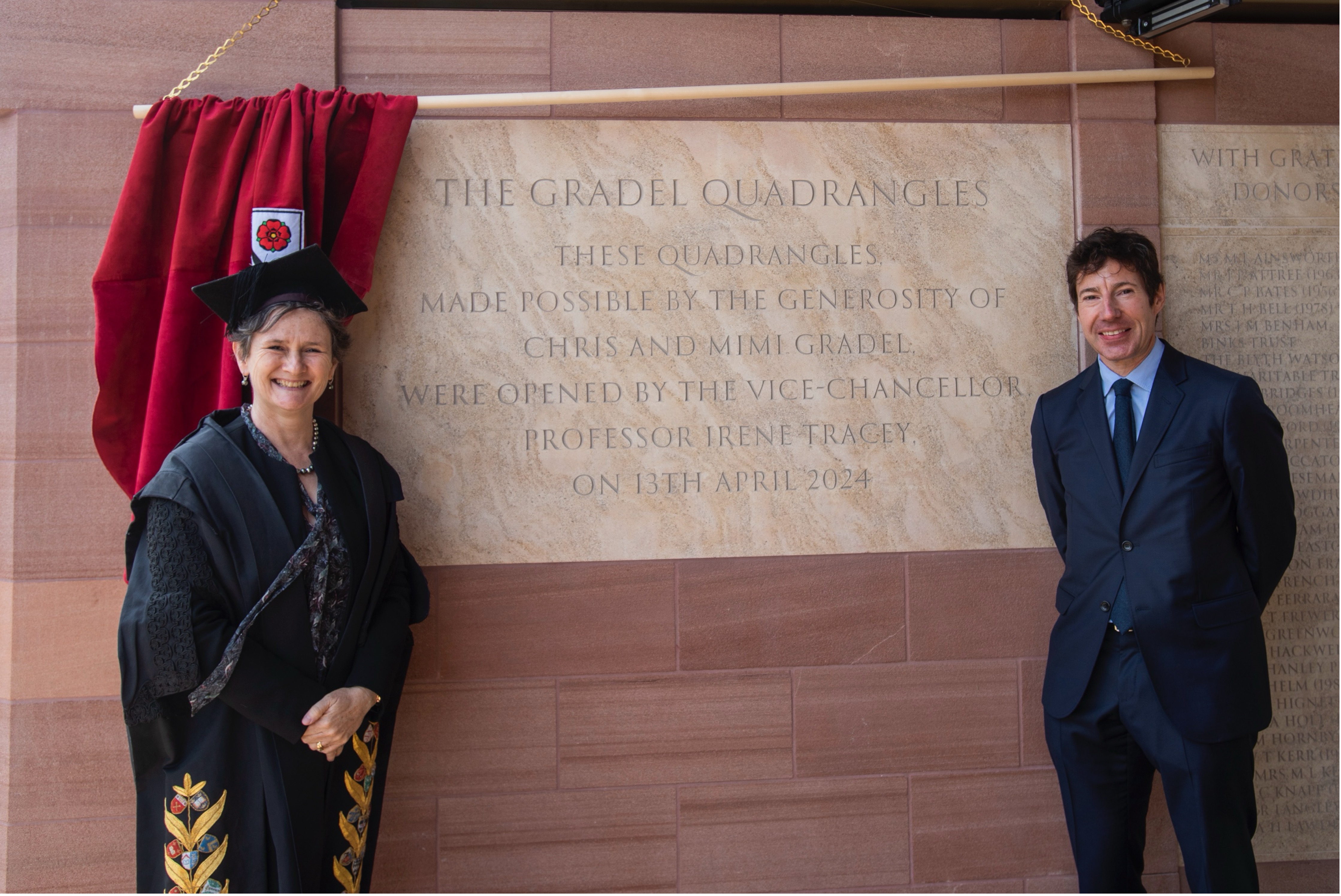 The VC and Chris Gradel stand by the ceremonial stone in New College's Gradel Quadrangles