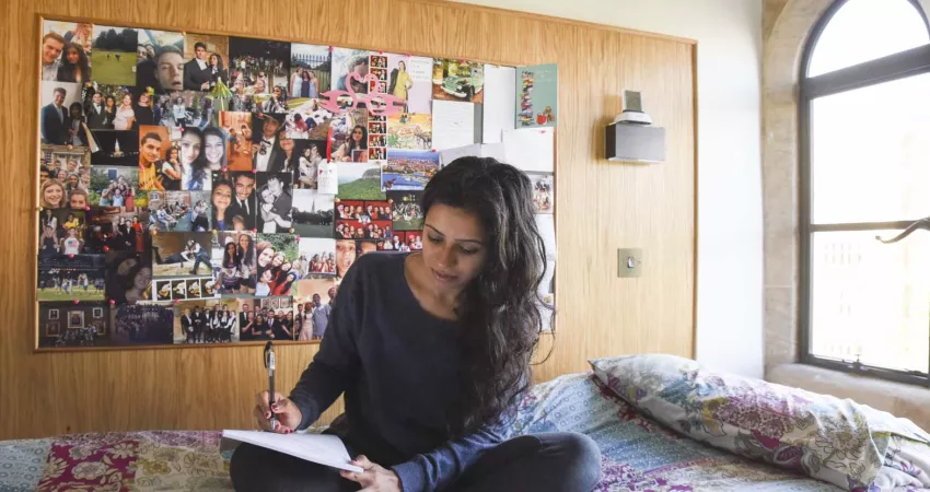 A Student in their room studying