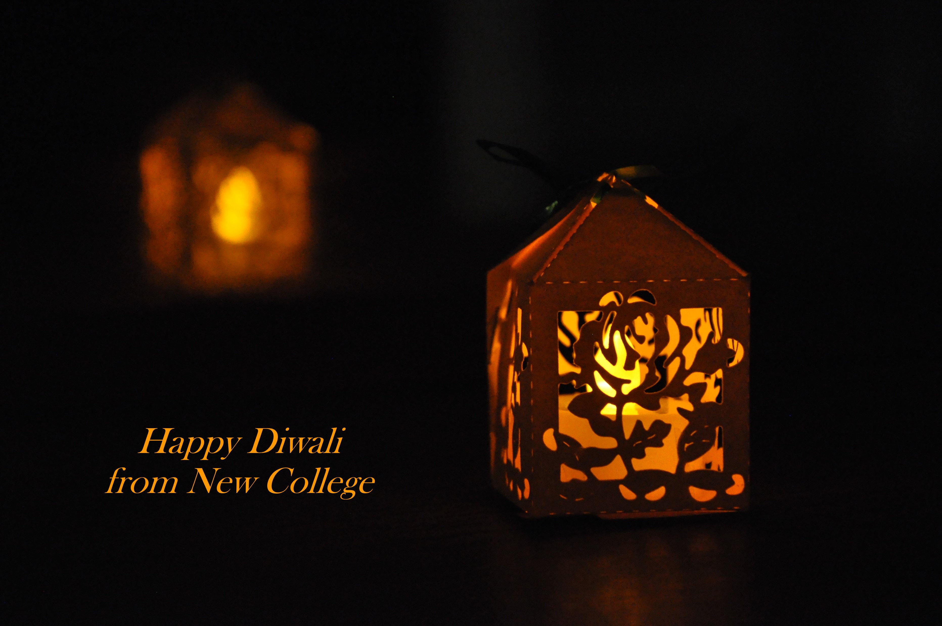 Small lantern containing a tea light, with the words 'Happy Diwali from New College' alongside