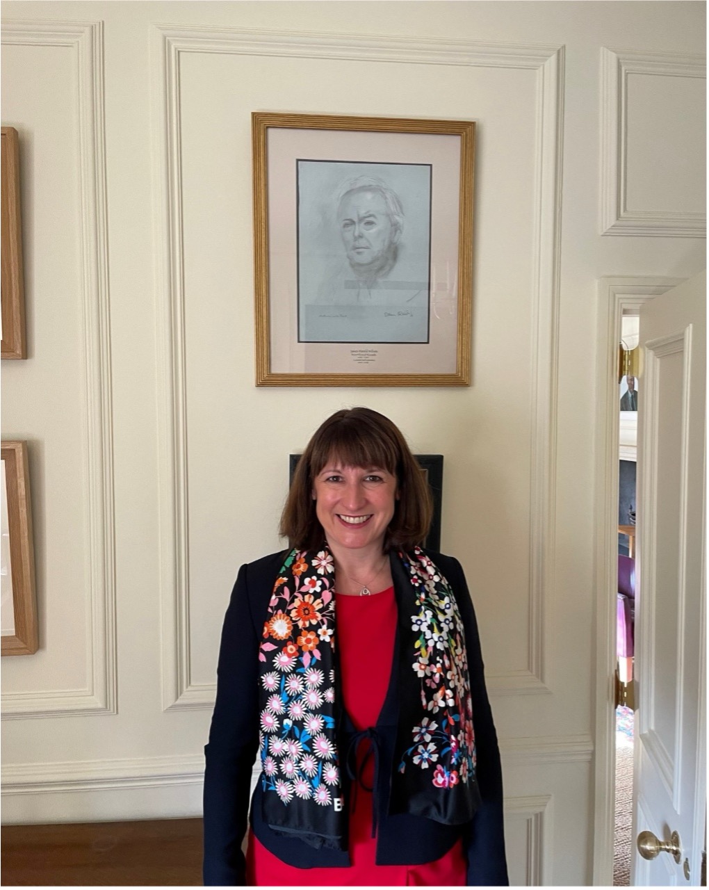 Rachel Reeves in front of the SCR portrait of Harold Wilson a former Lecturer in Economic History at New College