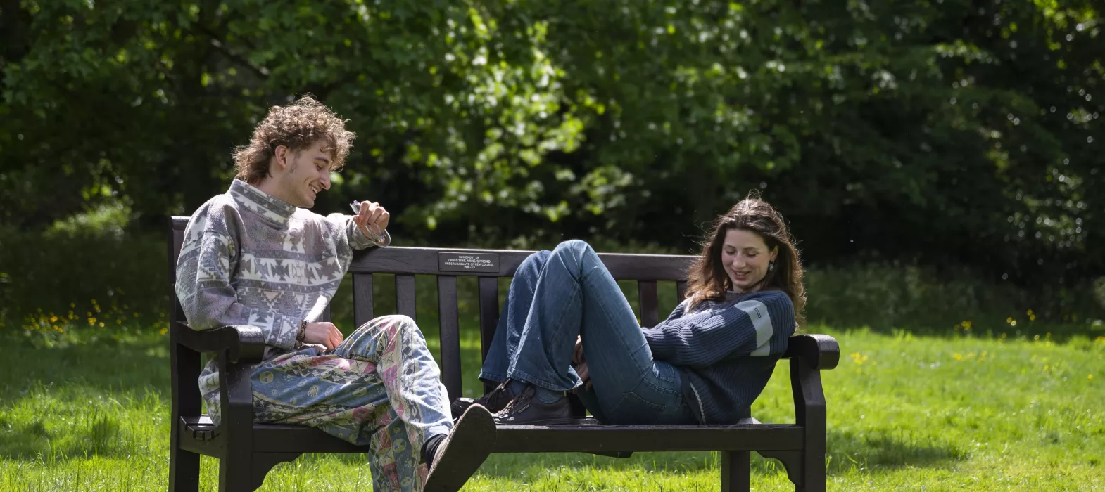 students lounging on a bench 