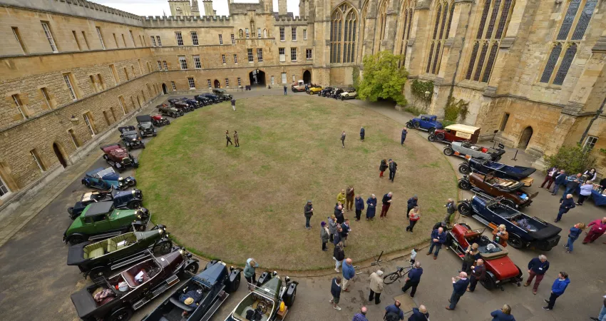 Old Morris cars parked around New College Front Quad
