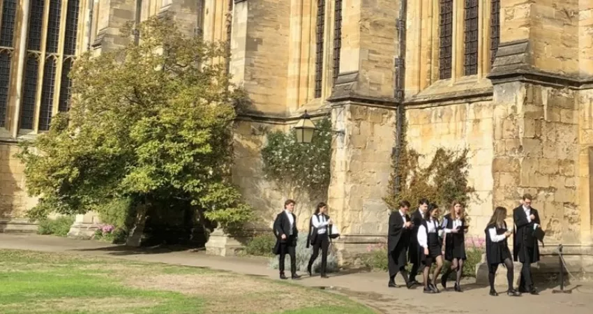 Students in sub fusc walking in the Front Quad