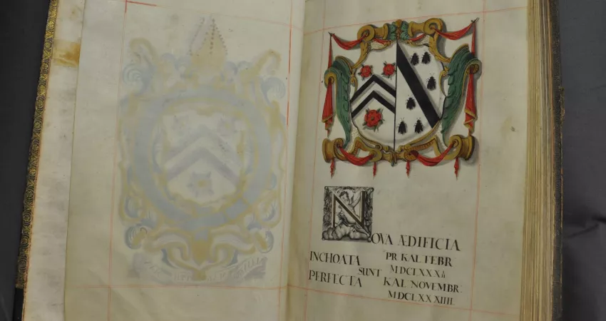 An old book with a drawn crest