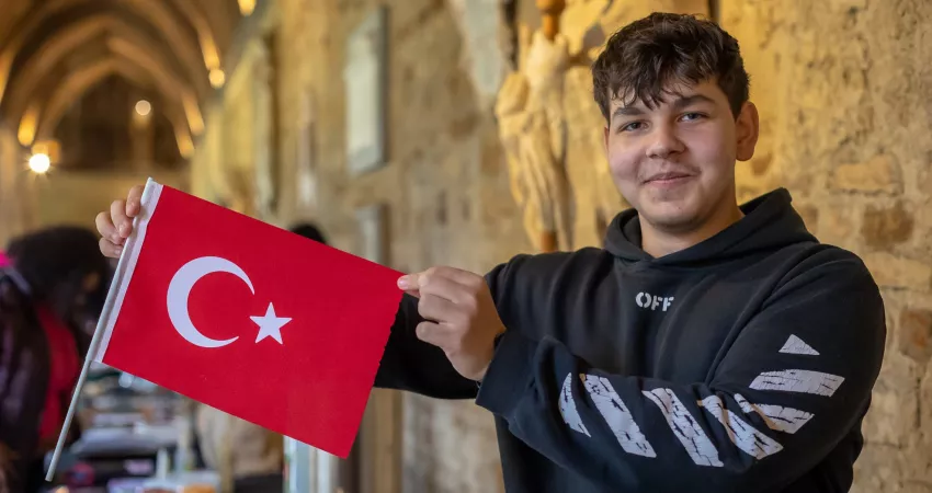 Student poses with a Turkish flag
