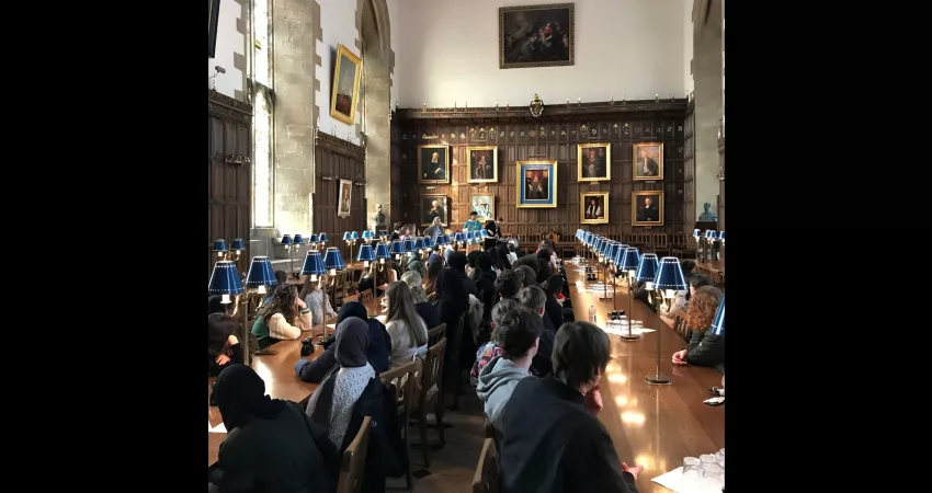 Students sat at long tables in a medieval dining hall