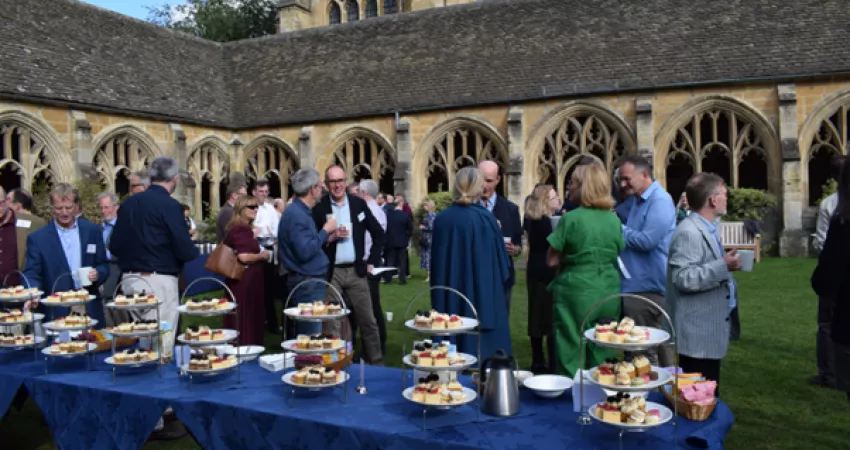 Afternoon tea is laid out in the cloisters as guests gather and chat