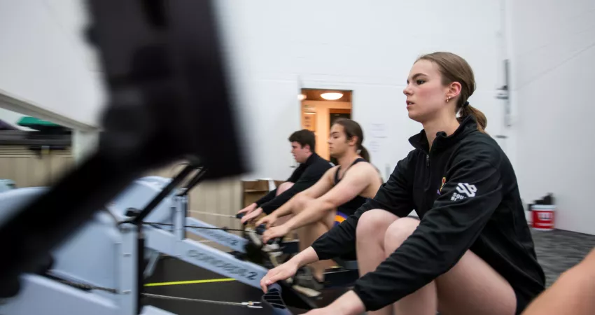 Students row on the ergs at New College Weston Sports Ground