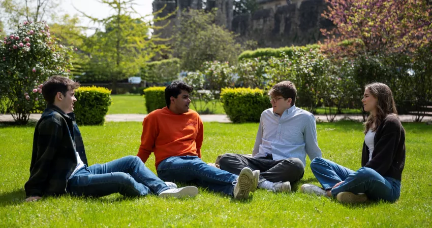 Students relaxing in the garden of Holywell Quad