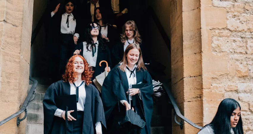 Graduands walking down the stairs from Hall 