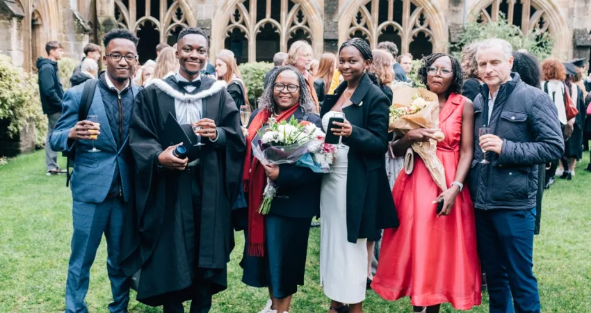 Graduate posing with family 