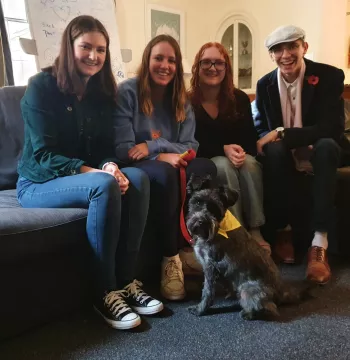 4 students with Eddy the miniature schnauzer