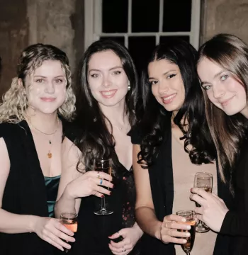Five students smiling with drinks