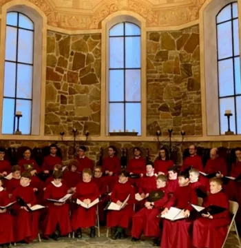 Choir in red robes sat in a Chapel
