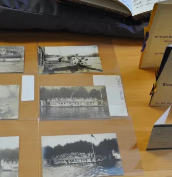 Old photographs featuring rowing; menus for celebratory dinners