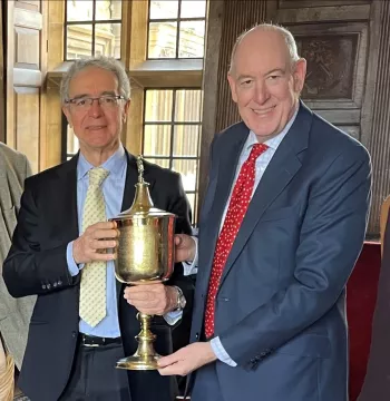 Spanish Ambassador and Warden holding a large, gold, 17th century cup